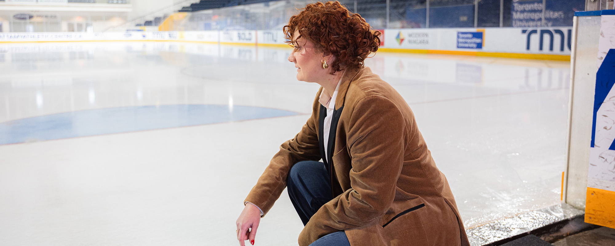 Dr. Stefania Impellizzeri kneeling and looking out onto an ice r