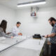 Three researchers using tools to test ice in an experimental rink